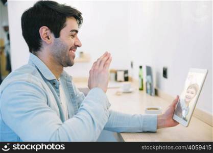 man talking with little child using tablet