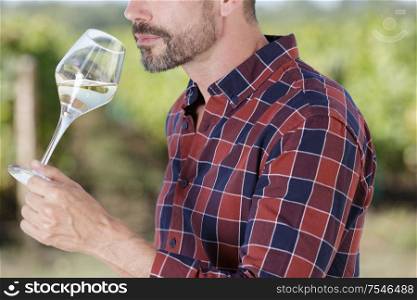 man tasting white wine