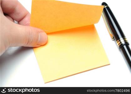 Man tearing yellow adhesive note