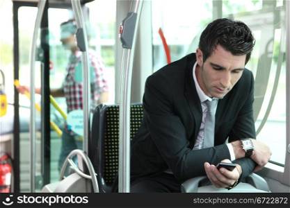 man texting in a bus