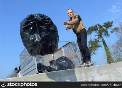Man throwing refuse bag
