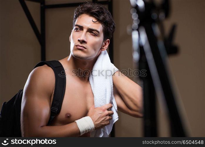 Man tired after workout in sports gym