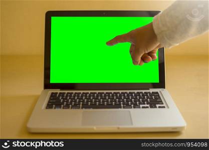 Man touch on screen with green color for replacement with blur background