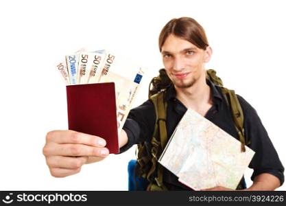 Man tourist backpacker holding money and passport.. Man tourist backpacker holding map and passport full of money. Young guy hiker backpacking. Summer vacation travel. Studio shot. Isolated on white background.