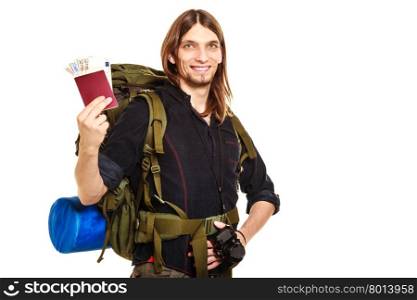 Man tourist backpacker holding money and passport.. Man tourist backpacker holding passport full of money. Young guy hiker backpacking. Summer vacation travel. Studio shot. Isolated on white background.