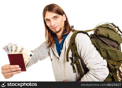 Man tourist backpacker holding money and passport.. Man tourist backpacker holding passport full of money. Young guy hiker backpacking. Summer vacation travel. Isolated on white background.