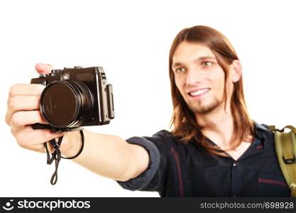 Man tourist backpacker on trip taking photo picture with camera. Young guy hiker backpacking. Summer vacation travel. Isolated on white background.. Man tourist backpacker taking photo with camera.
