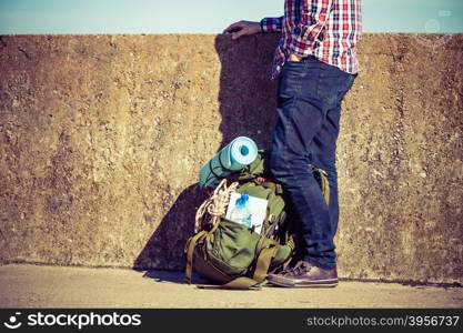 Man tourist backpacker outdoor with backpack on grunge wall. Adventure, summer, tourism active lifestyle. Young guy tramping