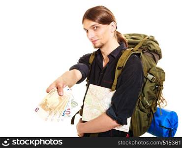 Man tourist backpacker paying with euro money holding map. Young guy hiker backpacking. Summer vacation travel. Isolated on white background.. Man tourist backpacker paying euro money. Travel.