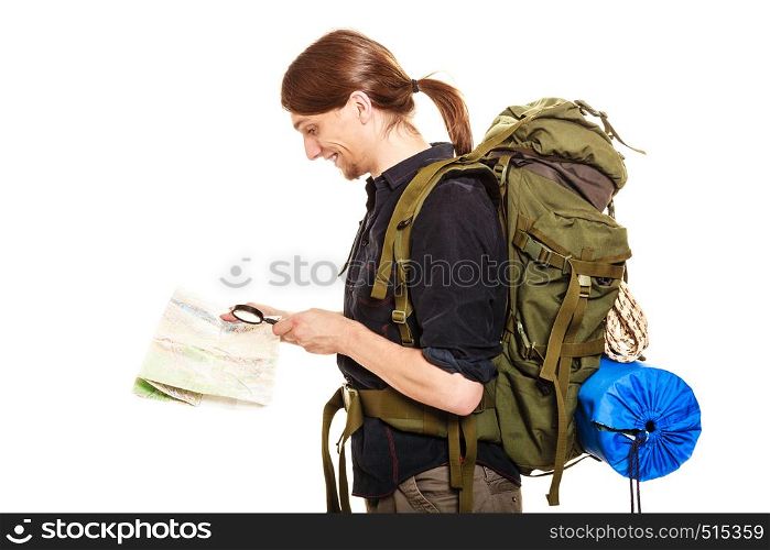 Man tourist backpacker reading map with magnifying glass loupe. Young guy hiker searching looking for direction guide. Male backpacking. Summer vacation travel. Isolated on white background.. Man tourist reading map with magnifying glass
