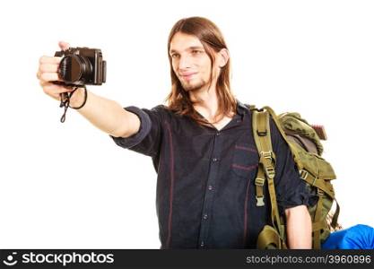 Man tourist backpacker taking photo with camera.. Man tourist backpacker on trip taking photo picture with camera. Young guy hiker backpacking. Summer vacation travel. Isolated on white background.