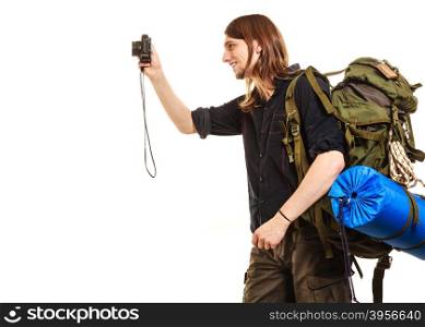 Man tourist backpacker taking photo with camera.. Man tourist backpacker taking photo picture with camera. Young guy hiker backpacking. Isolated on white background.