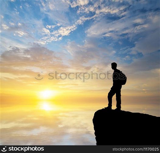 Man tourist looking on the sunset. Conceptaul scene.