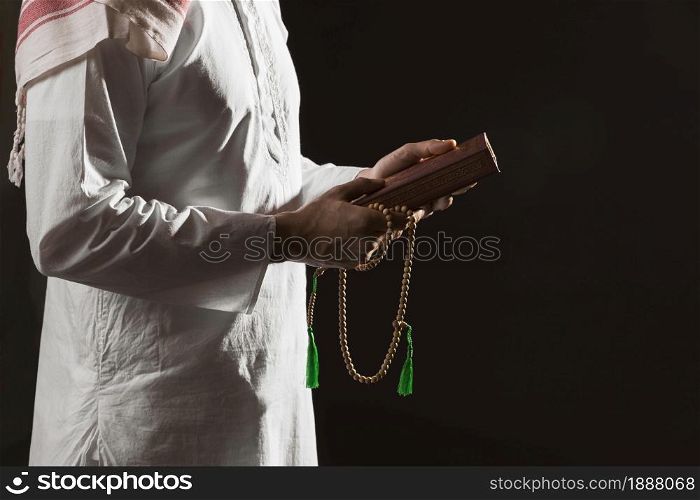man traditional arabic clothes holding quran. Resolution and high quality beautiful photo. man traditional arabic clothes holding quran. High quality and resolution beautiful photo concept