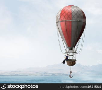 Man travel in aerostat. Businessman flying on aerostat balloon high in sky