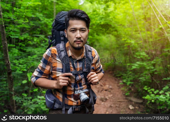 man traveler with backpack in the natural forest