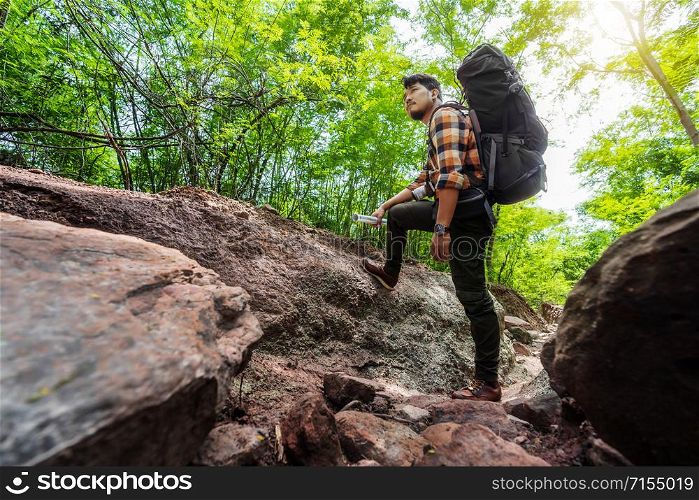 man traveler with backpack in the natural forest