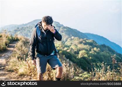 Man traveling with backpack hiking in mountains 