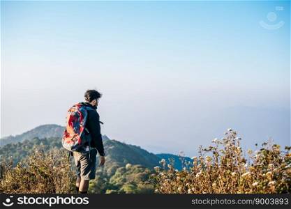 Man traveling with backpack hiking in mountains 