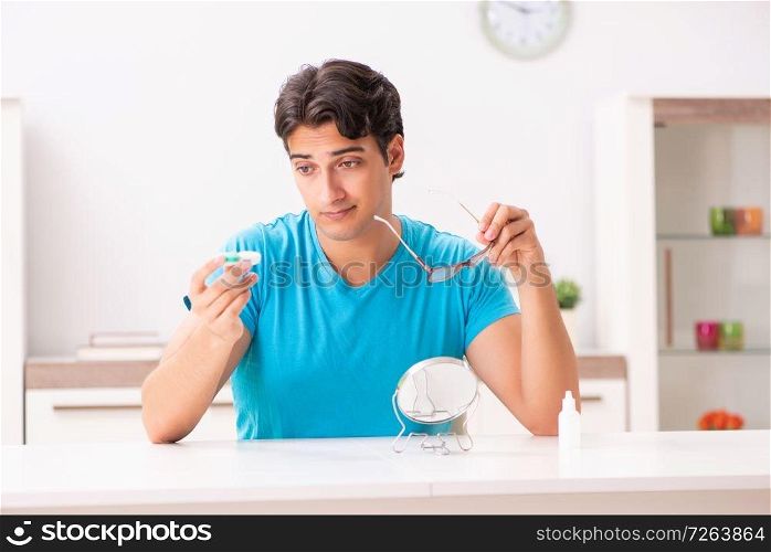 Man trying contact lenses at home. The man trying contact lenses at home