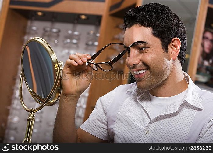 Man trying on eyeglasses in store