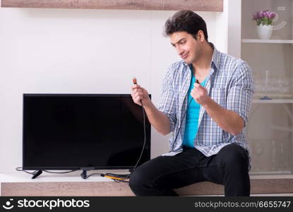 Man trying to fix broken tv