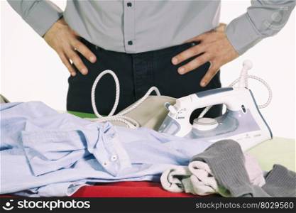 Man trying to iron clothes but has difficulty