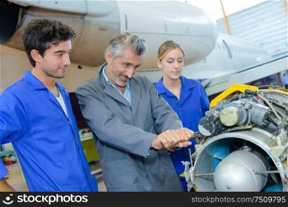 Man trying to lever part of aircraft engine