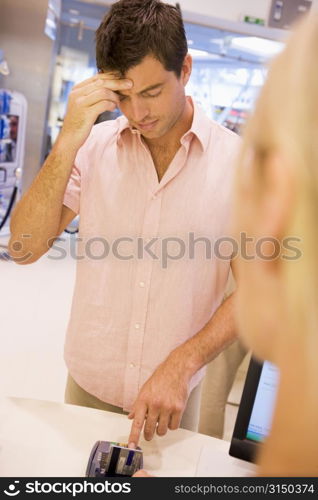 Man trying to remember credit card PIN number