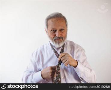 Man tying a tie. Elegant smart dressed man tying a tie with Half Windsor knot