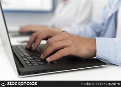 man typing laptop keyboard