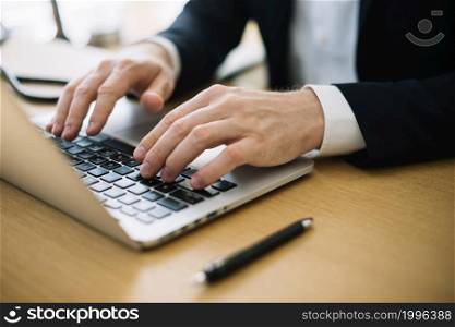 man typing laptop office