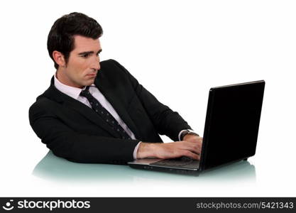 Man typing on his laptop.