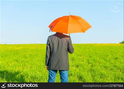 man under an umbrella on a sunny day in the field