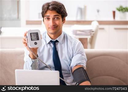Man under stress measuring his blood pressure. The man under stress measuring his blood pressure