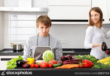 Man unhappy with cooking sitting in kitchen