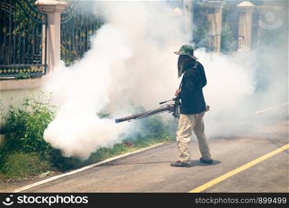 man use fumigation mosquitoes machine for kill mosquito carrier of Zika virus and dengue fever around the house