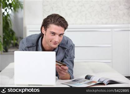 Man using a credit card to buy online