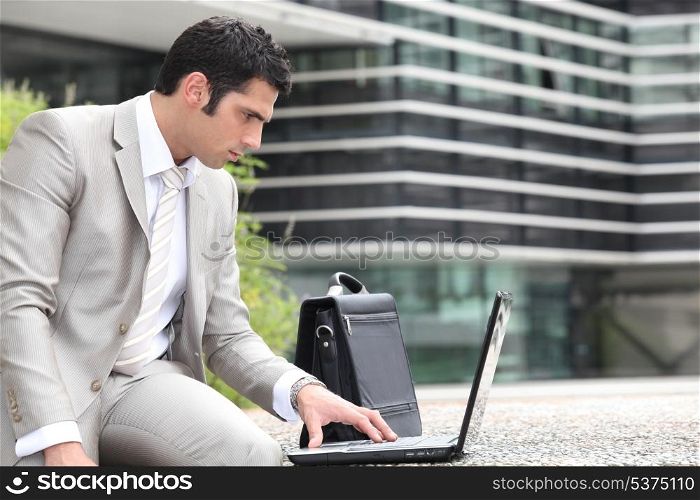 Man using a laptop outside