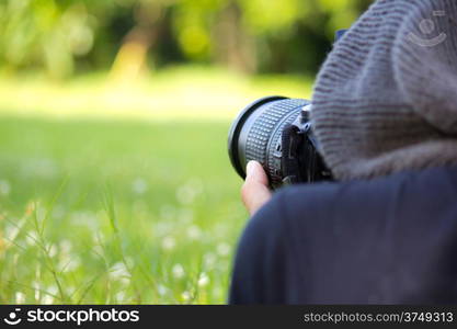 Man using a professional camera in the field