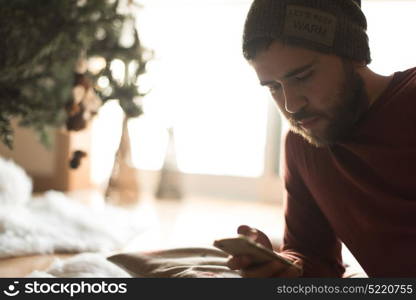 Man using a vaper and smartphone - Winter and Christmas Season