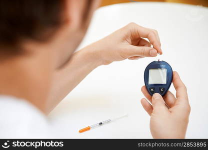 Man Using Blood Sugar Meter