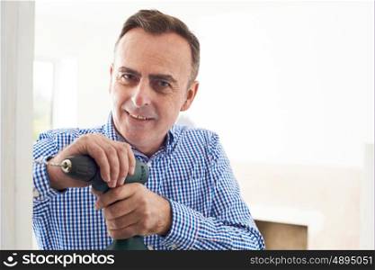 Man Using Electric Drill In House Renovation Project
