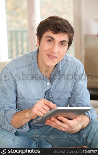 Man using electronic tablet at home