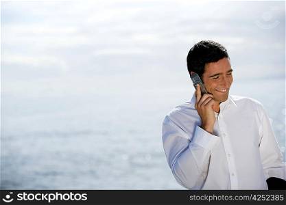Man using his cellphone by the sea