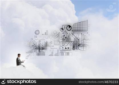 Man using his mobile phone. Young businessman sitting on cloud with mobile phone in hands