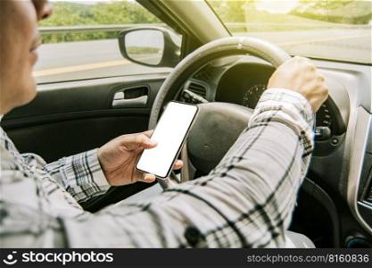 Man using his phone while driving, Person holding the cell phone and with the other hand the steering wheel, Concept of irresponsible driving, Distracted driver using the cell phone while driving