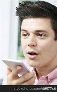 Man Using Internet Voice Search Technology On Mobile Phone