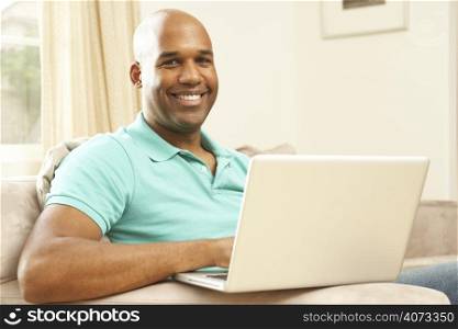 Man Using Laptop At Home