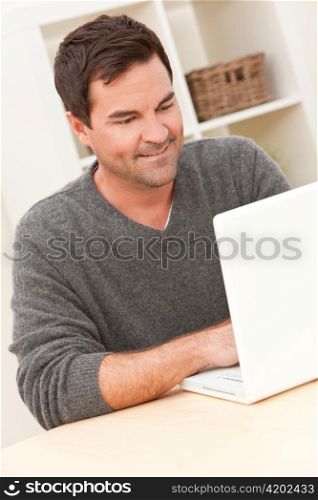 Man Using Laptop Computer At Home